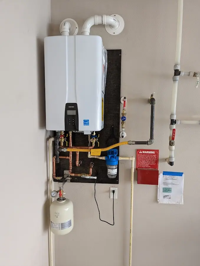 Professional plumber installing copper piping in a Bloomingdale home